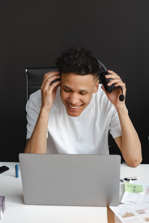 Professional laughing as he puts on his headset at the start of a shift